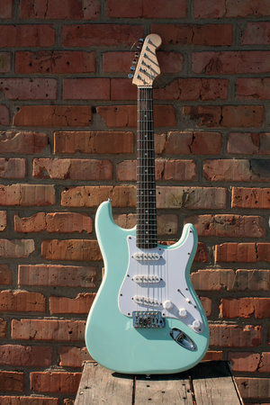 an electric guitar on a brick wall isolatedの写真素材