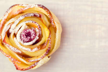 apple muffin with raspberry in the centre on a wooden light backgroundの写真素材