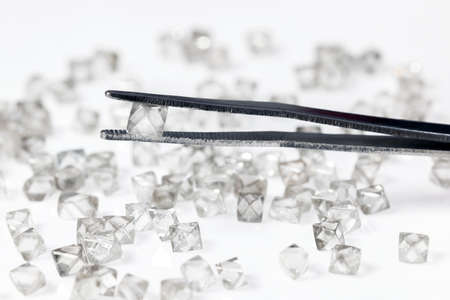 Natural  transparent diamond in tweezers in macroの写真素材