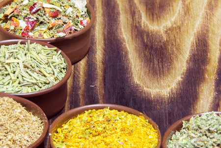 various spices in containers on a wooden backgroundの写真素材