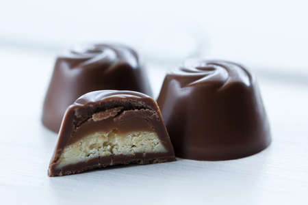 Chocolate candy in a cut with a milk-caramel filling, in macroの写真素材