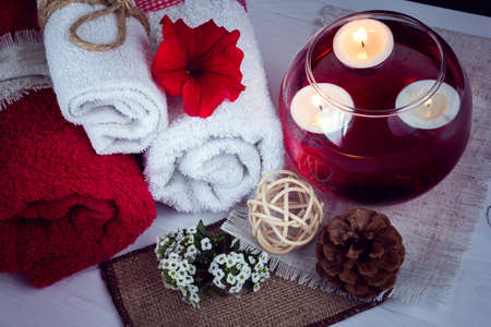SPA consist from towels, candles, flowers, and aromatherapy water in a glass bowlの写真素材