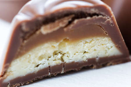 Chocolate candy in a cut with a milk-caramel filling, in macroの写真素材
