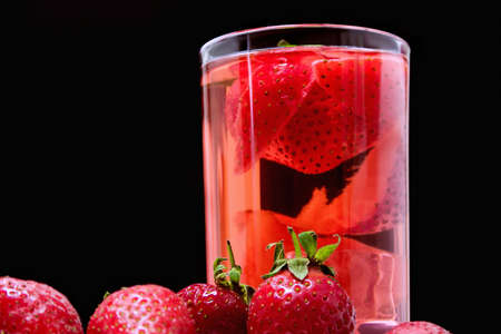 Detox with strawberries and ice on a black backgroundの写真素材