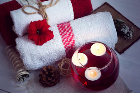SPA consist from towels, candles, flowers, and aromatherapy water in a glass bowlの写真素材