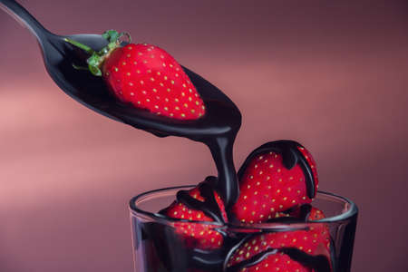 The strawberry in a glass watered with chocolateの写真素材