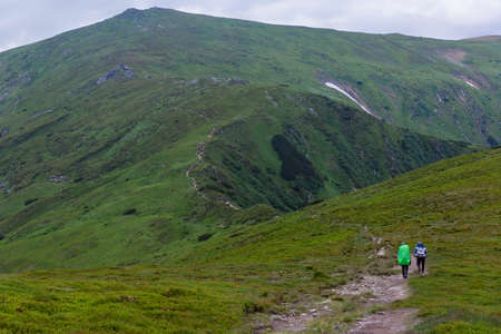 the tourists rise to the top of the mountainsの写真素材