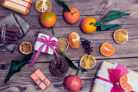 different gifts with tangerines, cinnamon and cone. Christmas still lifeの写真素材