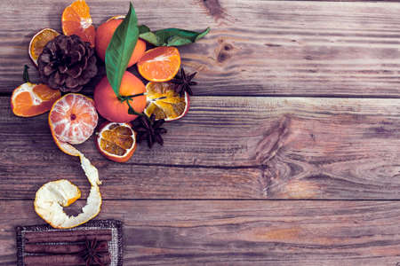 bouquet of tangerines, cone anise and cinnamon on a wooden backgroundの写真素材