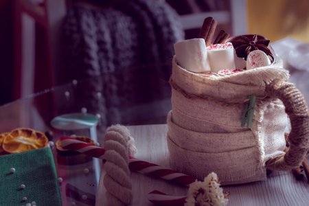 Warm and cozy winter still life, consist of, cup of coffee and marshmallow in the home interior...