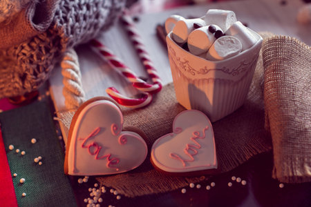 Warm and cozy winter with cup of coffee and marshmallow and ginger snap in the shape of heart. Still life for St. Valentine's Dayの写真素材