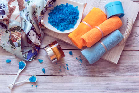 SPA consist from bathrobe, towels and blue sea salt on a wooden trayの写真素材