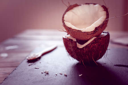 two half of coconut on a wooden backgroundの写真素材