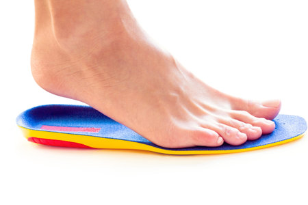 orthopedic insole and female leg above it