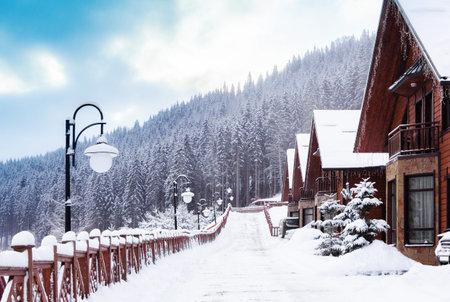 winter city in the mountains with houses and road in the centre