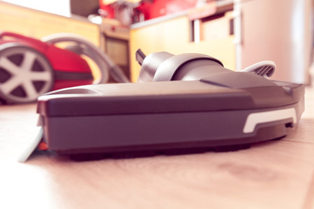 vacuum cleaner on the laminate on the background of the kitchen