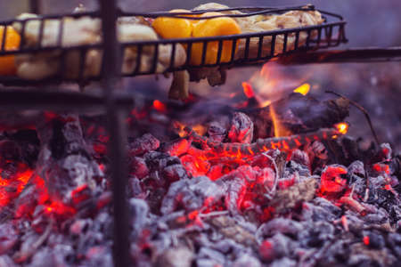 Preparation of meat and vegetations on a metal brazierの写真素材
