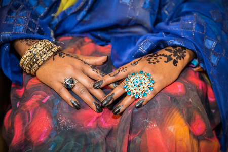 Black and Brown Henna Hands Drawings on Women for African Wedding Ceremony with Big Ringsの写真素材