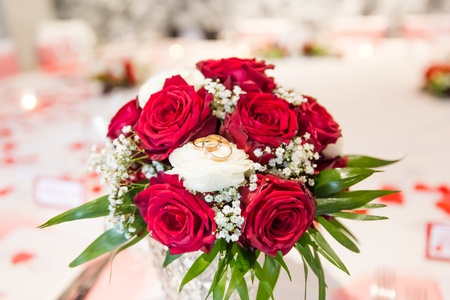 Wedding Rings on White and Red Roses Bridal Bouquetの写真素材