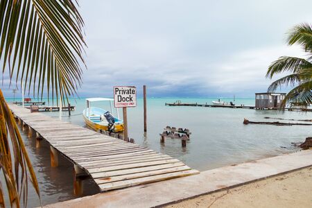 Small Boat, Mooring Posts and Private Dock Signの写真素材