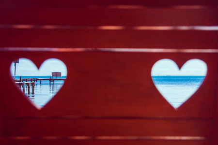 Caribbean Sea through Red Beach Bench Hearts