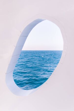 White Boat Crackled Window on Blue Sea and Skyの写真素材