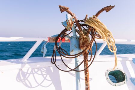 Rusty Anchors on Dive Boat Deck in the Sun with Sea in the Backgroundの写真素材