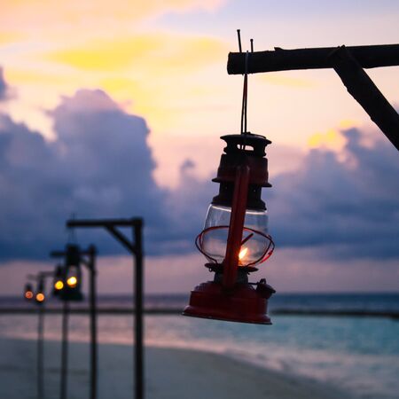 Beach Oil Lamp Lighting and Pacific Ocean at Dusk in Maldives Islandの写真素材