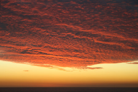 Dramatic Volcanic Crimson Sunset over Pacific Oceanの写真素材