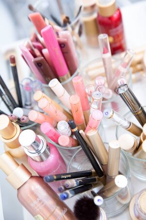 Multi Coloured Make-up (Foundation, Blush, Mascara and Lipsticks) on a Beautician Tableの写真素材