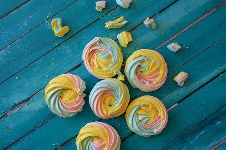Colorful meringues on wooden backgroundの写真素材