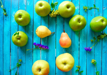 Fresh fruit apples and pears on a blue backgroundの写真素材