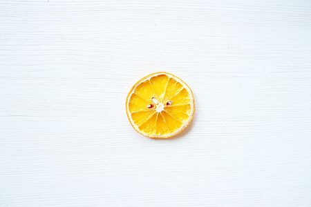 Slice of dried orange on white backgroundの写真素材