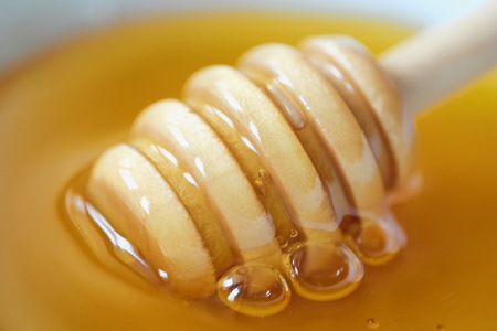 Delicious flower honey and wooden stickの写真素材