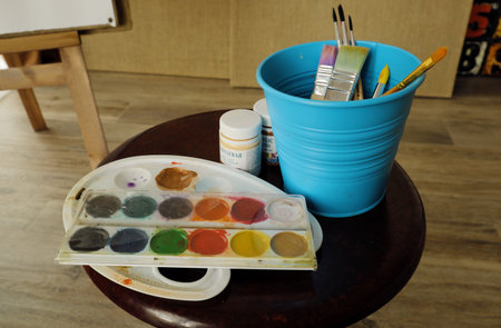 Paint and paint brushes on paper viewの写真素材