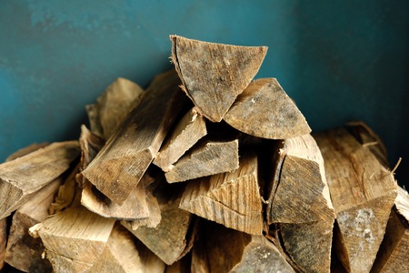 Brown firewood for the fireplace on a blue backgroundの写真素材