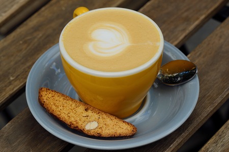 A mug of delicious cappuccino and croutons with nutsの写真素材