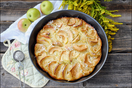Delicious Apple pie with powdered sugar and fruits