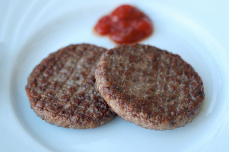 Delicious dinner meat patties with ketchup view