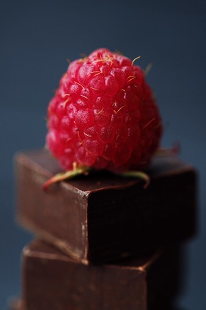 Delicious dark chocolate and ripe pink raspberriesの写真素材