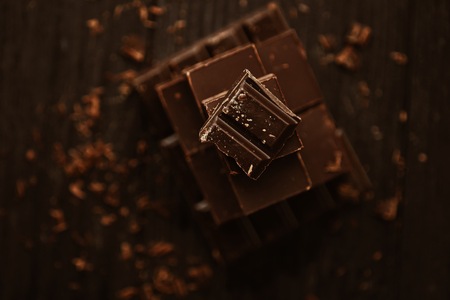 Delicious black and milk chocolate on a brown backgroundの写真素材
