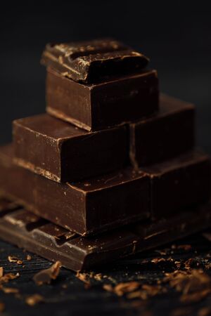 Delicious black and milk chocolate on a brown backgroundの写真素材
