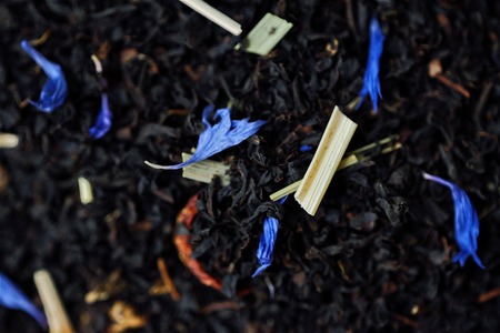 Black tea with lemon peel and flower petalsの写真素材