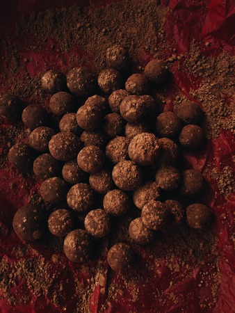 Delicious chocolate truffles in red paper viewの写真素材