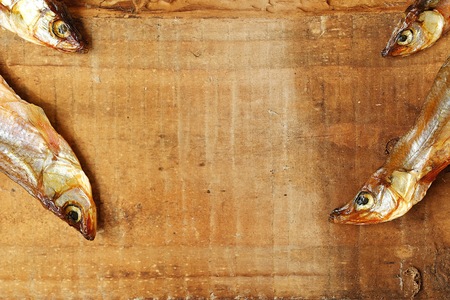 Dried fish with salt on a wooden backgroundの写真素材