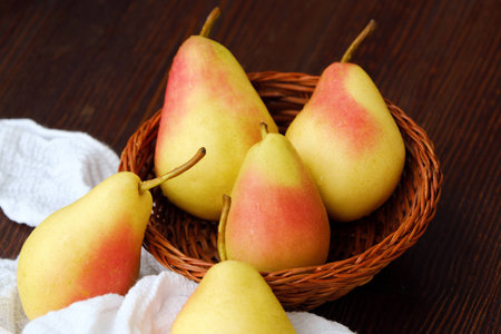 Juicy ripe yellow pears in a wooden tableの写真素材