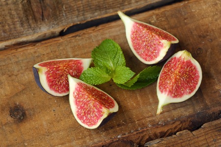 Delicious fresh figs with mint on the tableの写真素材