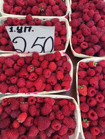 Fresh ripe tasty raspberries on the market