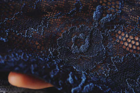 Beautiful delicate openwork dark blue lace in hand
