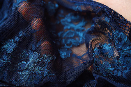 Beautiful delicate openwork dark blue lace in handの写真素材